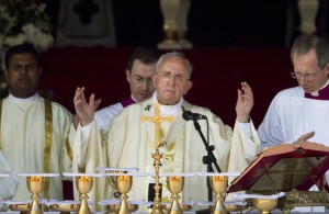 Pope Francis raises his hands during Mass at Colombo's seafront Galle Face Green for the canonization ceremony of Joseph Vaz, Wednesday, Jan. 14, 2015. Francis declared Vaz a saint at the start of the service. The church considers Vaz a great model for today's faithful, ministering to the faithful of both Sri Lanka's ethnic groups and putting himself at great risk to spread the faith. (AP Photo/Saurabh Das)